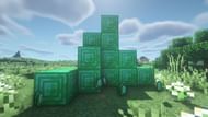 A lot of Emeralds and Emerald blocks (Image via Minecraft)